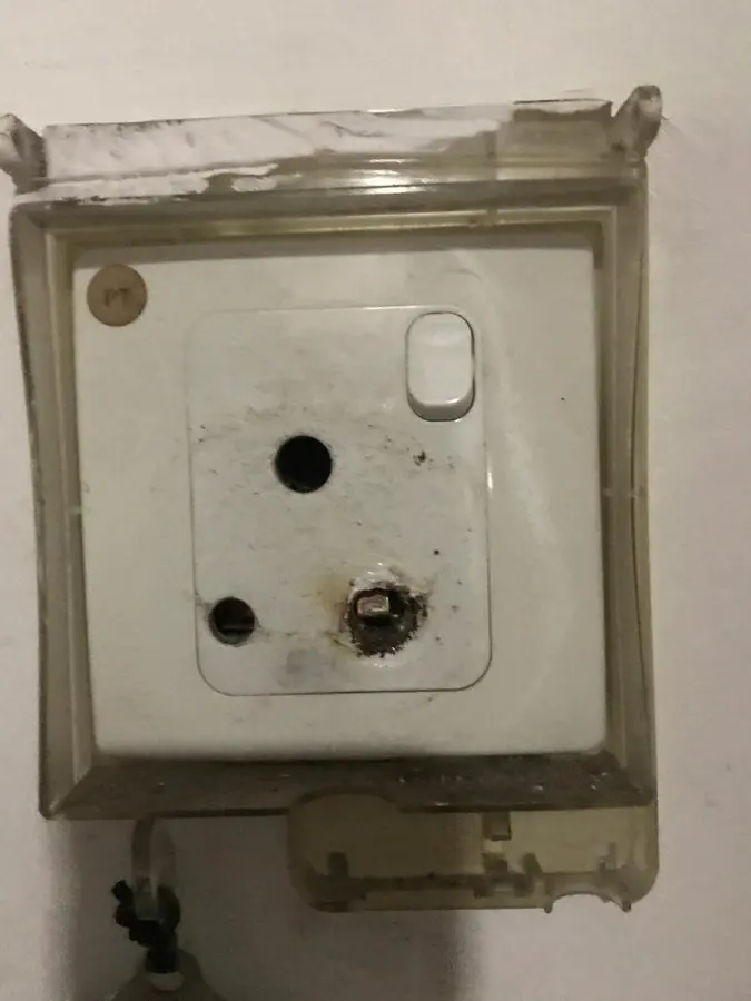 Burnt 13A plug and socket requiring replacement by an electrician
