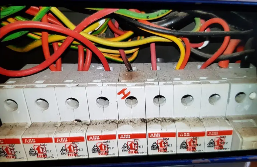 Circuit breaker wiring close-up during a power trip repair