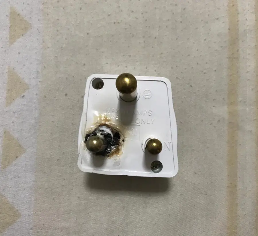 Damaged power socket needing replacement in a Singapore home